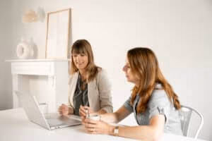 student receives study coaching at a table